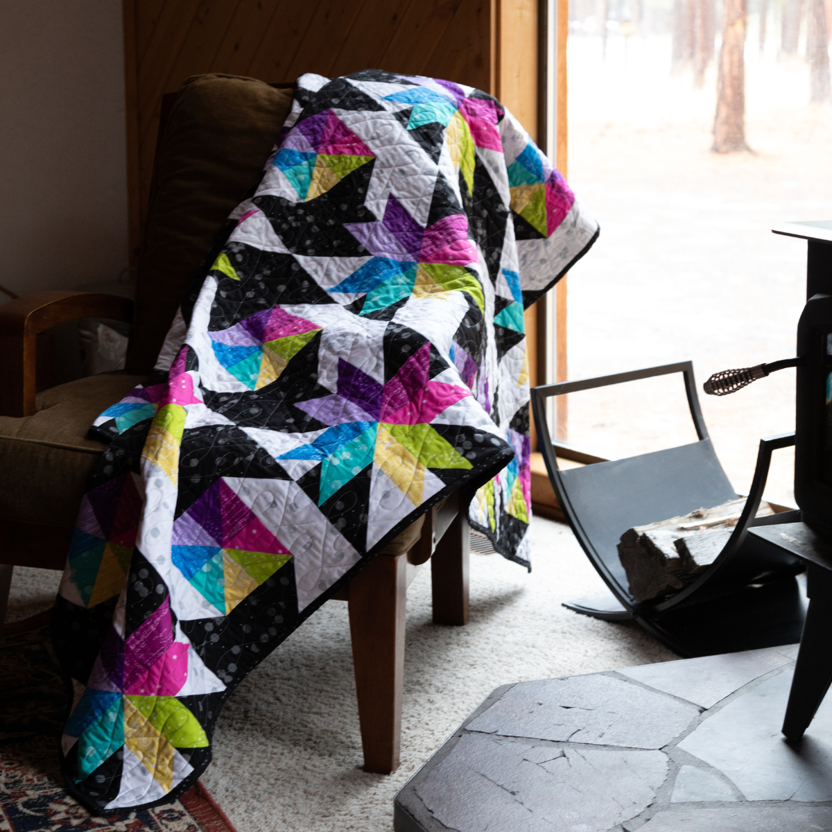 Stars at Sea quilt draped over a chair, contemporary FIGO star quilt