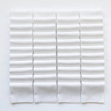 White Supreme 5 inch precut squares laid out in a grid, 42 charm squares