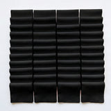 Black Supreme 5 inch precut squares laid out in a grid, 42 charm squares